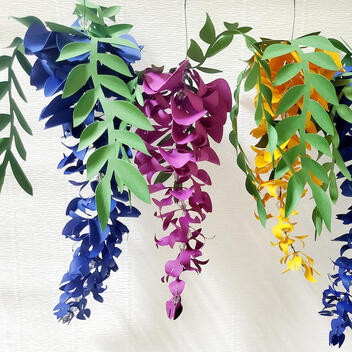 Vibrant Handmade Paper Wisteria Garland, featuring 12 flowers in assorted lengths of 20cm and 30cm, ideal for wedding and garden party decorations, or as a permanent home decor piece